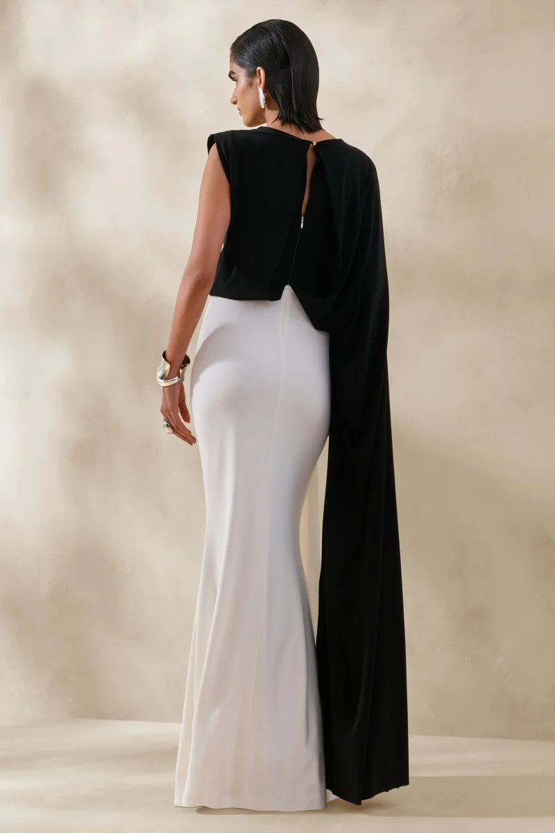 Carenza | Vestido Largo Negro y Blanco con Escote Asimétrico y Manga Tipo Capa - Imagen 3