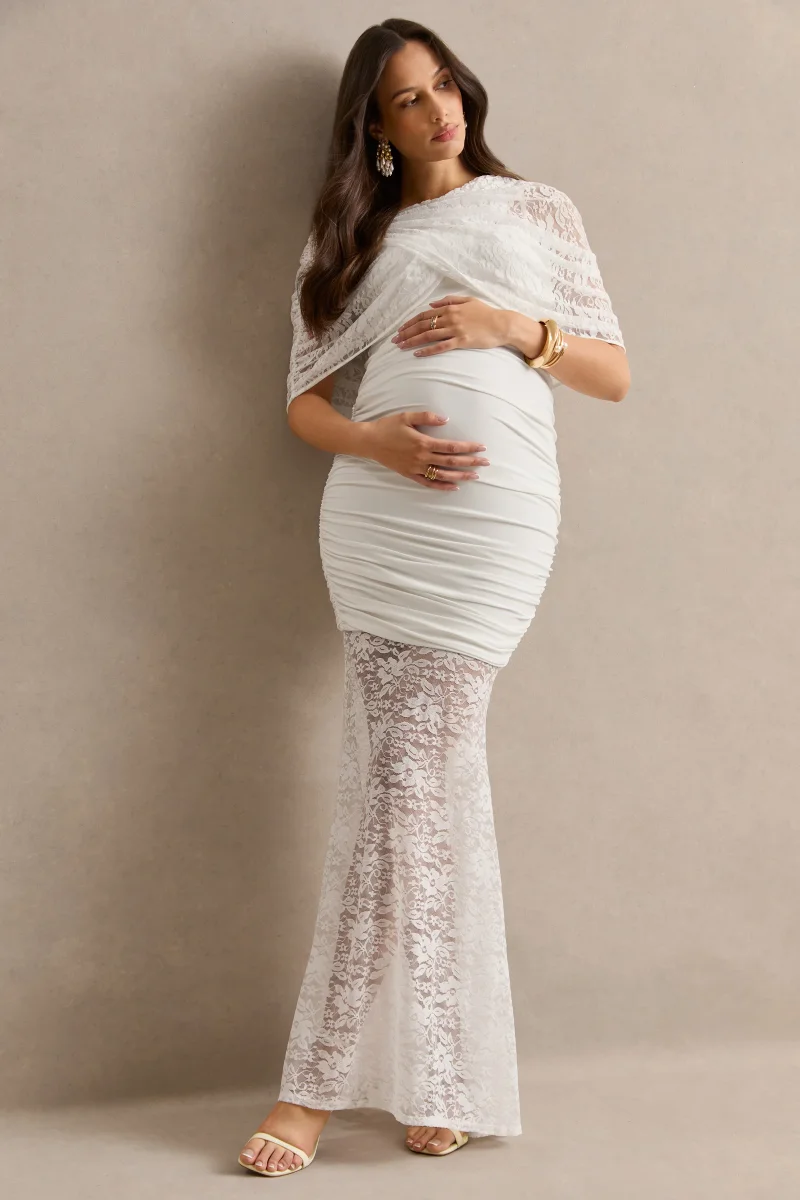 Bronta | Vestido Premamá Largo Blanco De Encaje Con Cuello Alto, Capa Corta Y Falda Transparente - Imagen 2