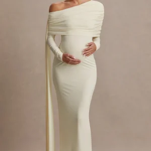 Cyra | Vestido largo crema con escote asimétrico y fajín